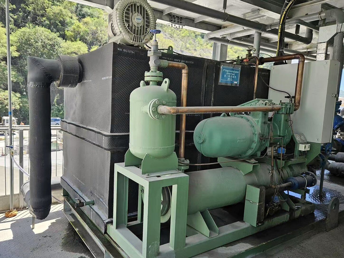 Second-stage cooling package with compressor, vessel and insulated process equipment