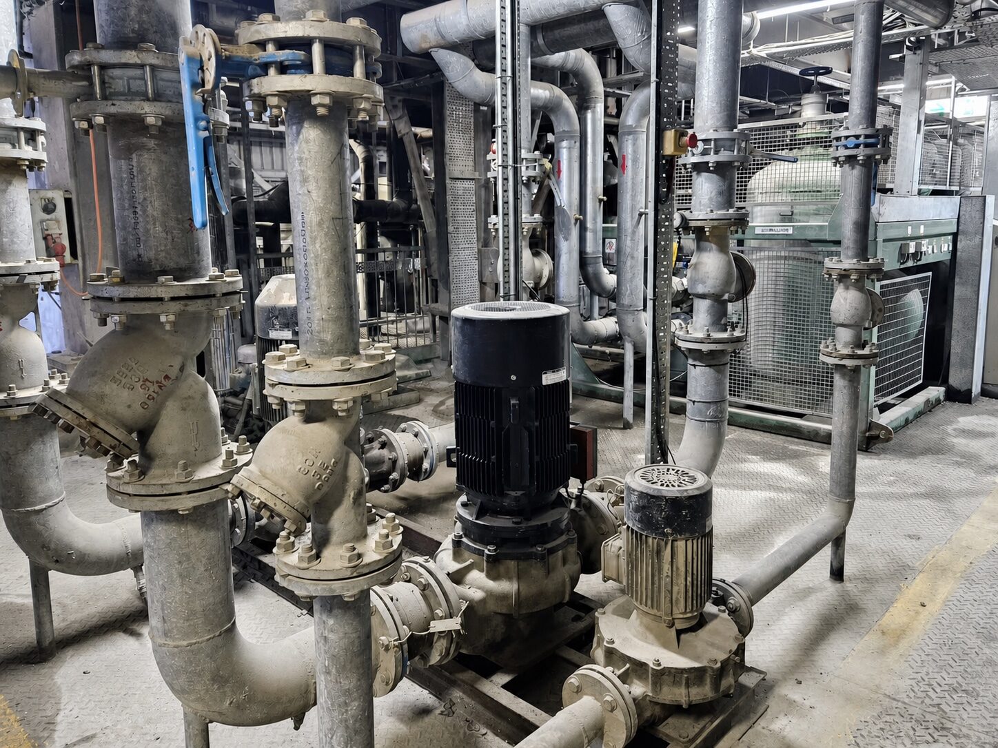 Industrial pumps, valves and insulated pipework inside the Hong Kong concrete-cooling installation