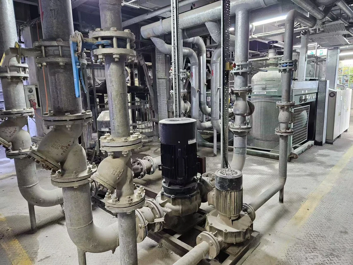 Water pumps, valves and connected pipework installed beside refrigeration equipment